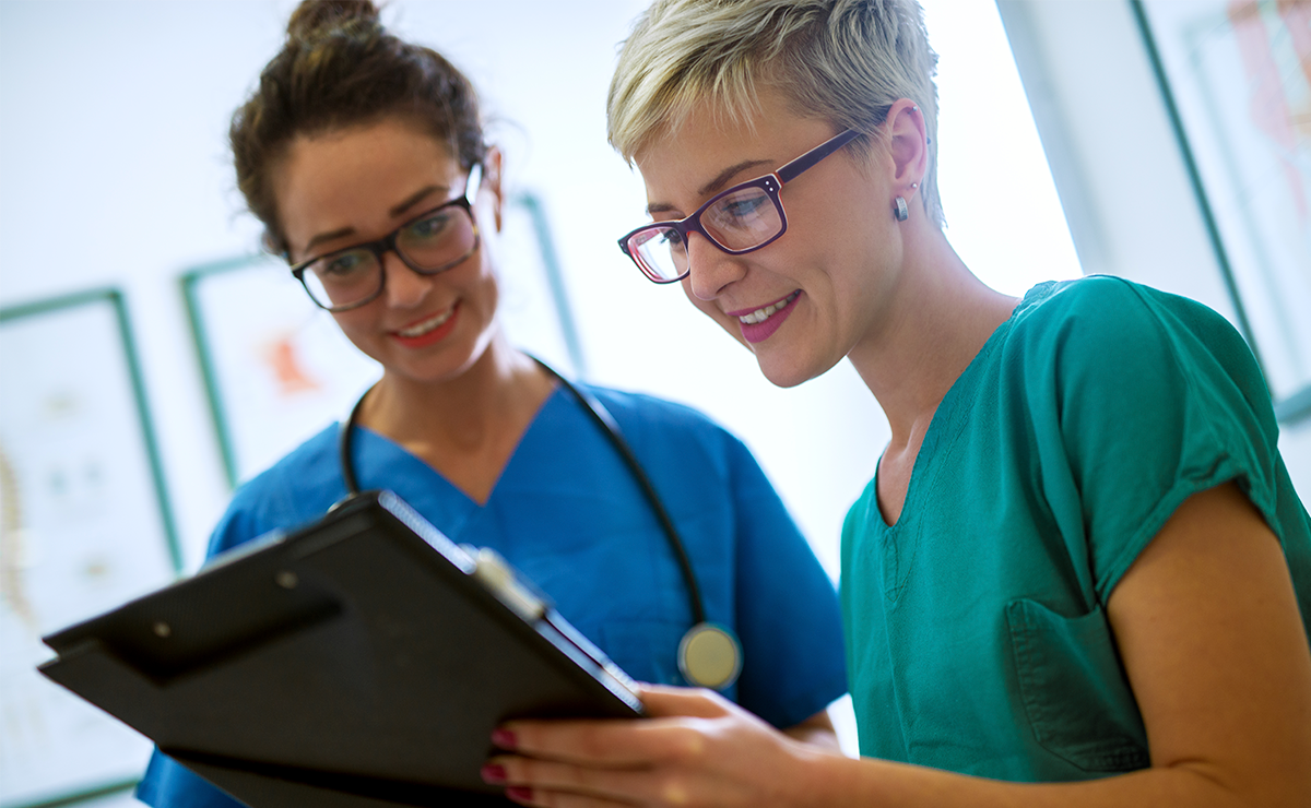 Two medical professionals review a chart. Healthicity Customer Story image.